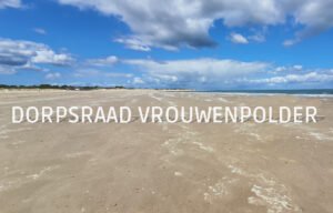 Strand bij Vrouwenpolder met letters die staan op het zand met tekst: "dorpsraad Vrouwenpolder"